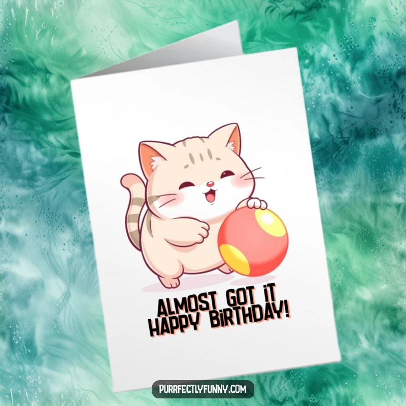 Funny Free Printable Birthday Card: Plump cat hilariously misses brightly colored ball, perfect DIY funny downloadable gift.