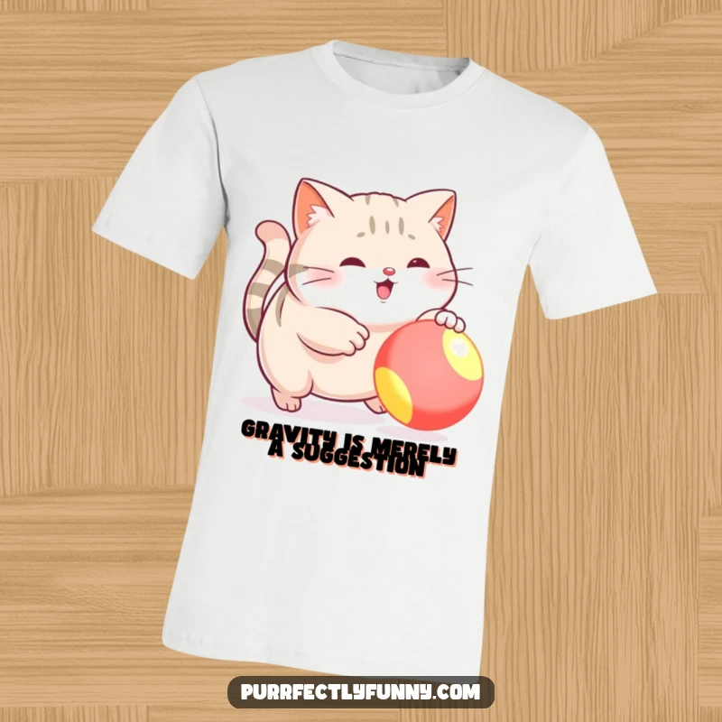 Funny t-shirt featuring a plump cat comically lunging for a bright, bouncy ball, capturing the essence of feline playfulness.